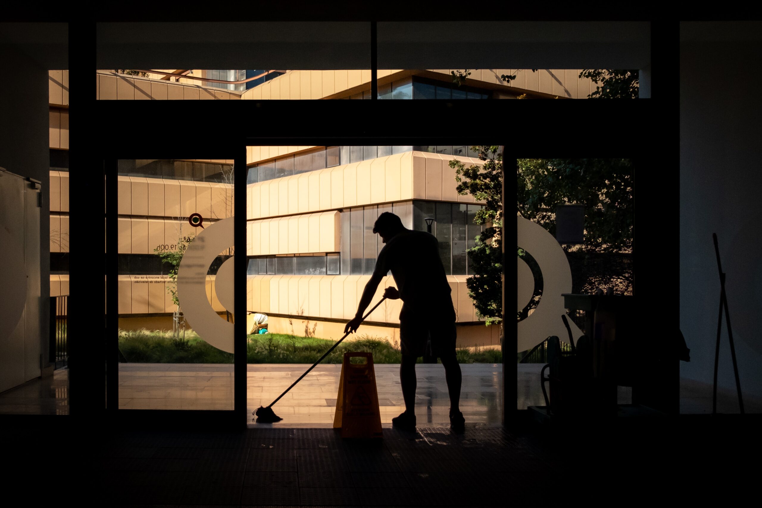 white man moping in front of building